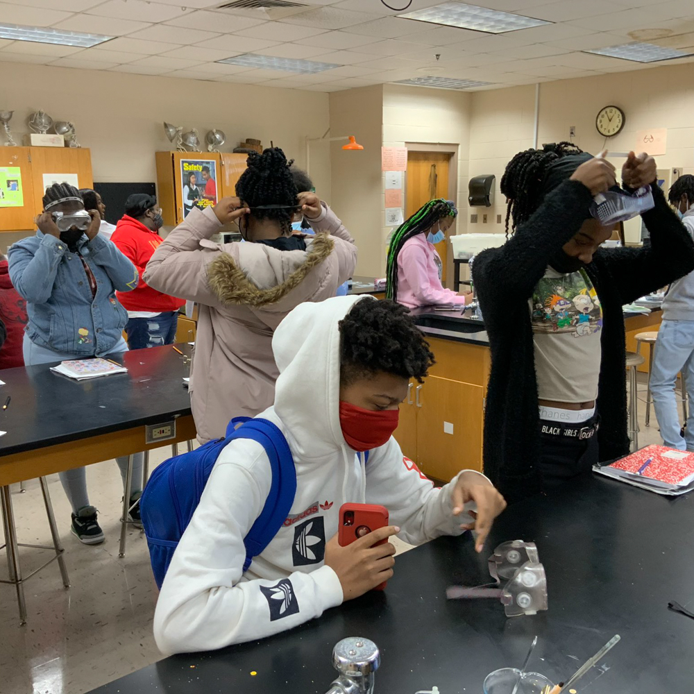 Students inside the laboratory wearing goggles