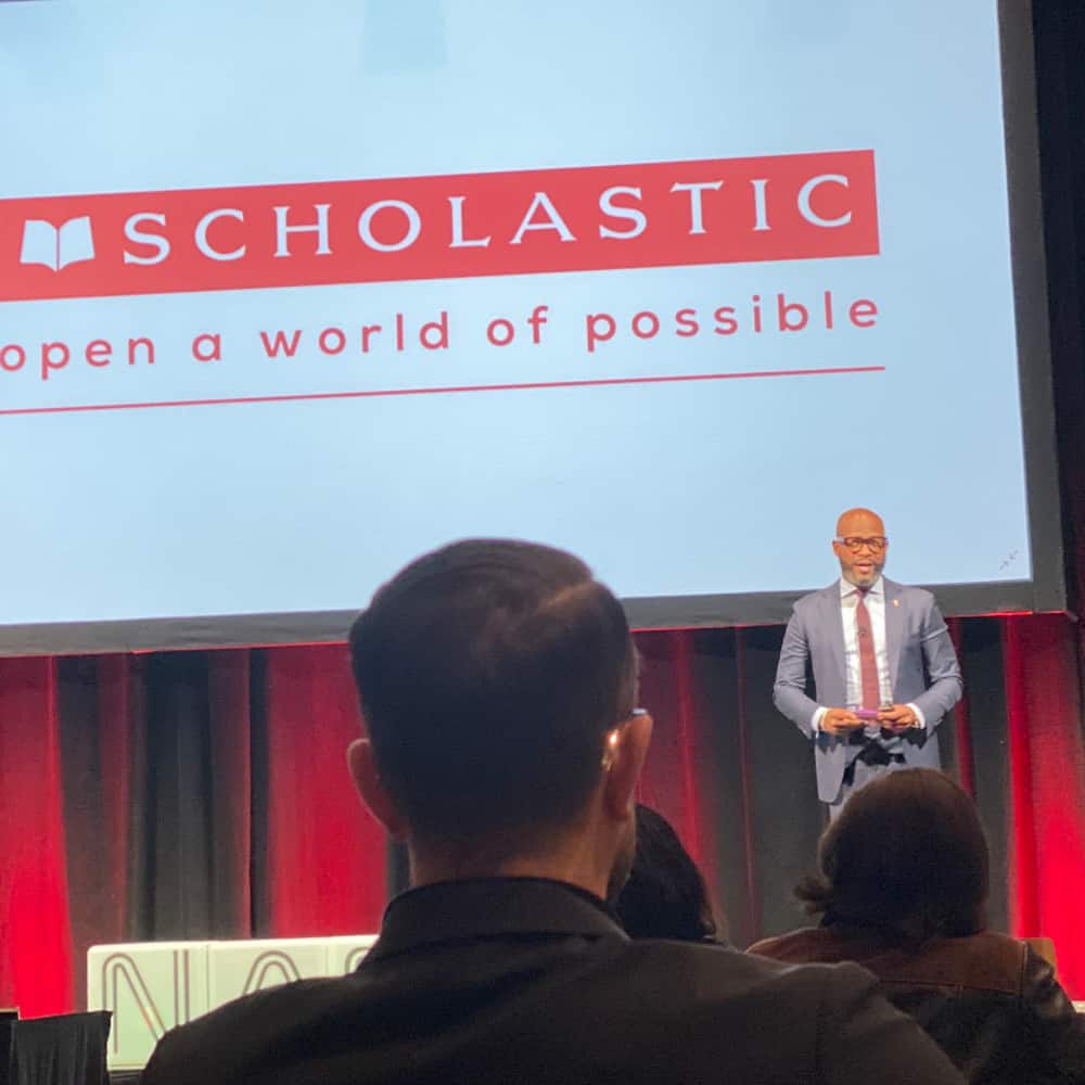Dr. Dickey during scholastic event speaking on stage